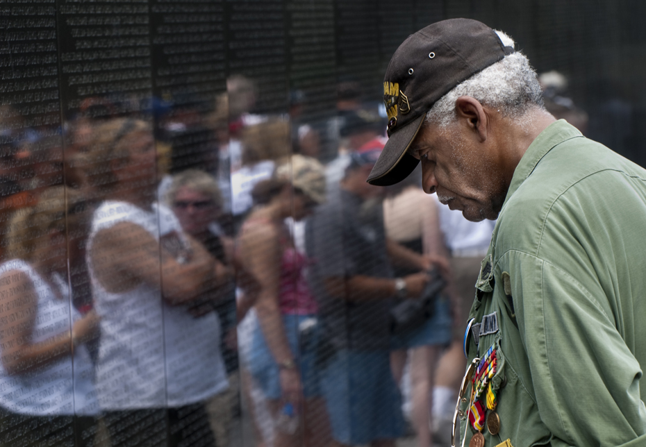 20070527212 Charles J. Smith stood in the same spot in front of the Vietnam Veterans Memorial for more than an hour.Wearing a green army jacket and holding a framed photograph behind his back, Smith bowed his head and stared at a name inscribed on the granite monument. The name was that of a friend, James E. Pierce.