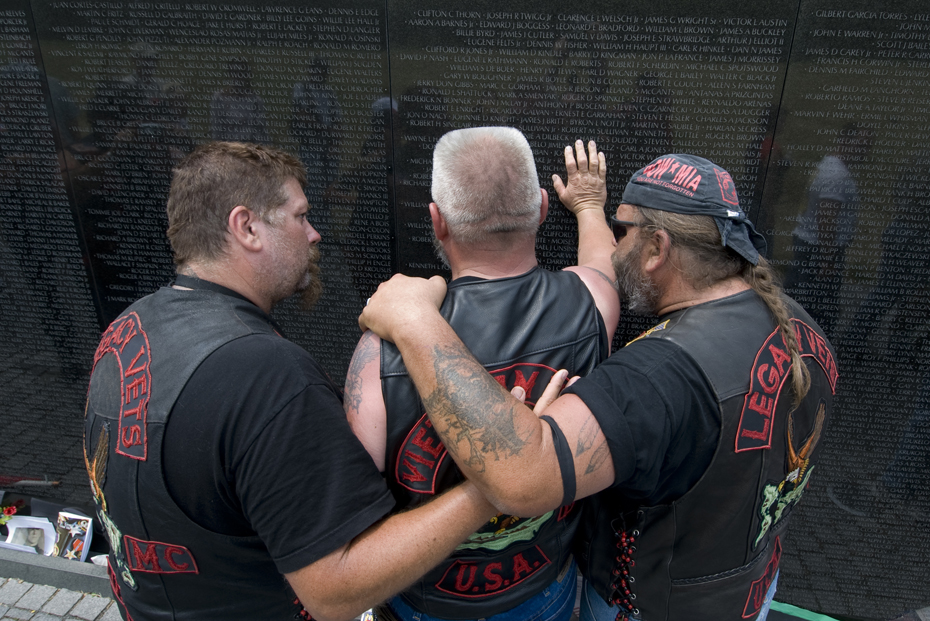 20070527427 Two veterans of the Vietnam war comfort a comrade during his visit to the Vietnam Veteran's Memorial in Washington, D.C.
