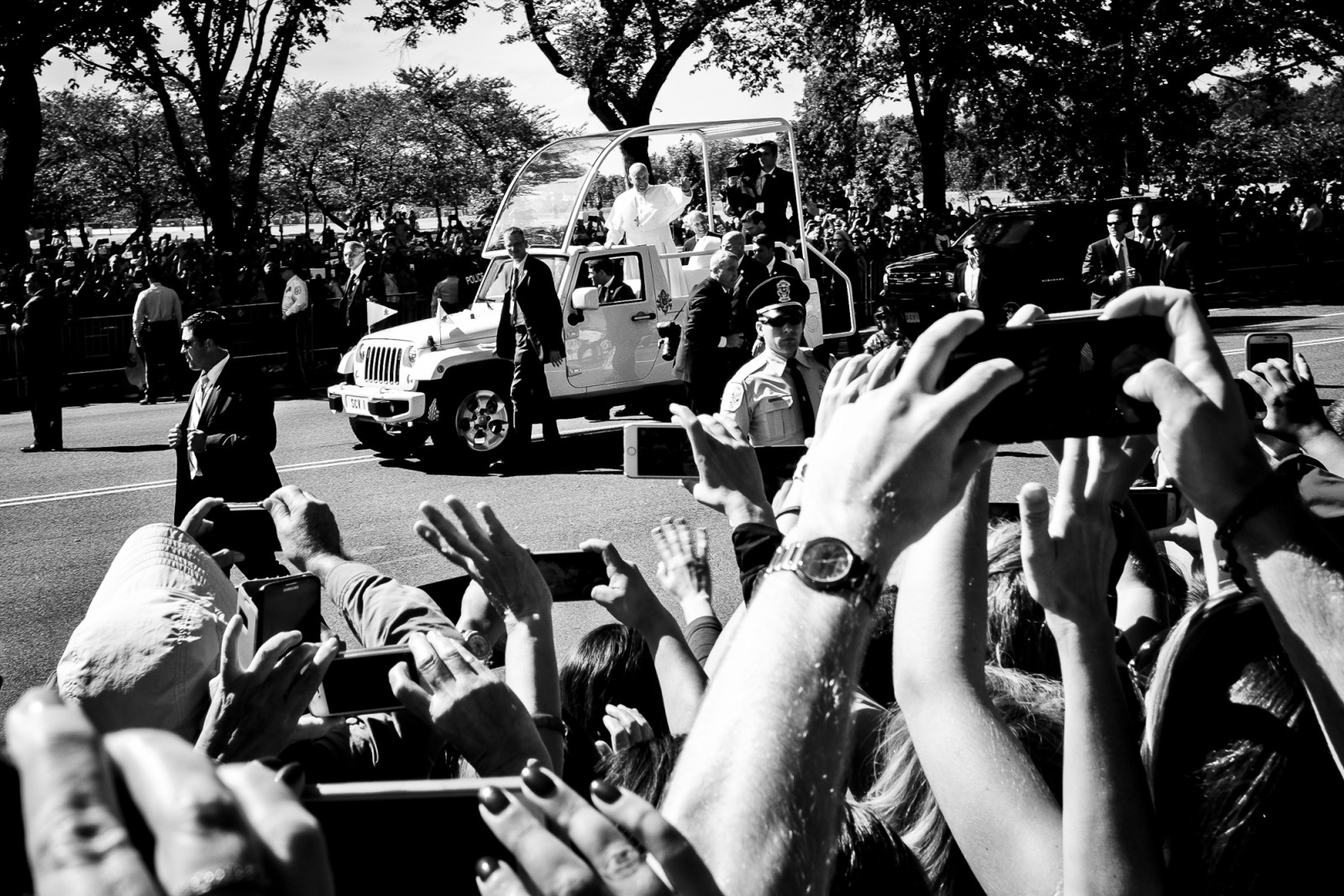 Spectators cheer for Pope Francis as he passes by in his “popemobile,” as he is driven on the streets around the Ellipse, south of the White House in Washington, District of Columbia, U.S., on Wednesday, Sept. 23, 2015.  Credit: Pete Marovich/Bloomberg