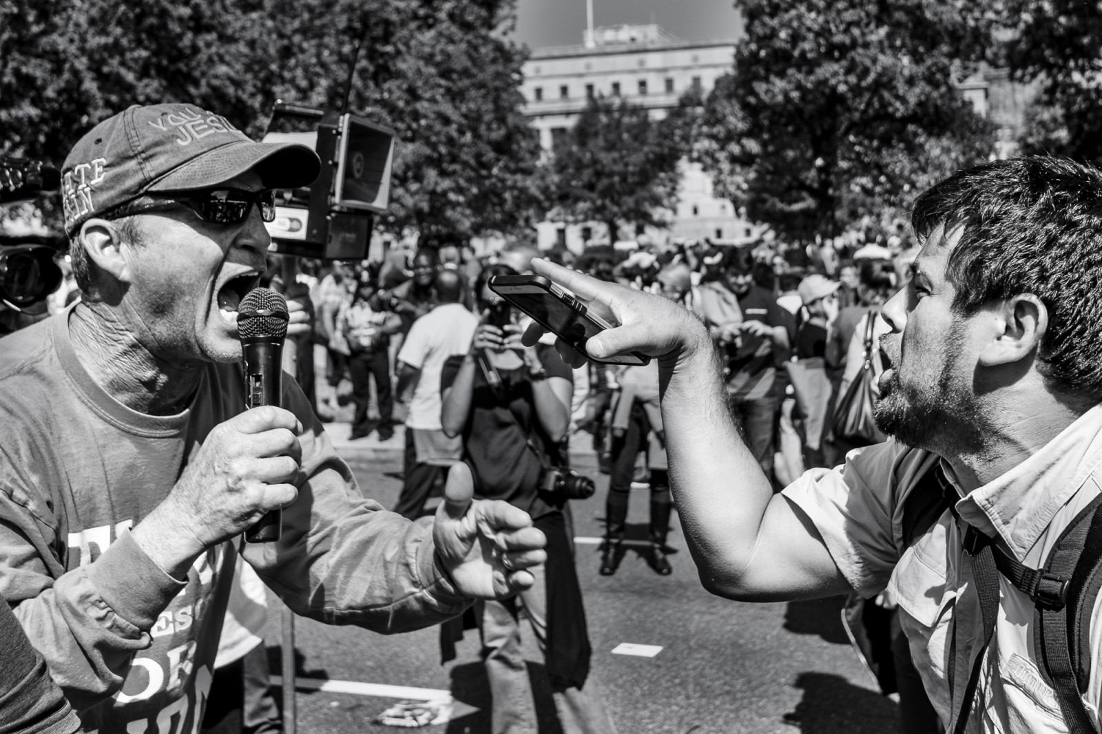 A man from the Los Angeles chapter of Bible Believers (left) and an fan of Pope Francis clash in a war of words following a short parade where Pope Francis was driven on the streets around the Ellipse, south of the White House in Washington, District of Columbia, U.S., on Wednesday, Sept. 23, 2015.  Credit: Pete Marovich/Bloomberg