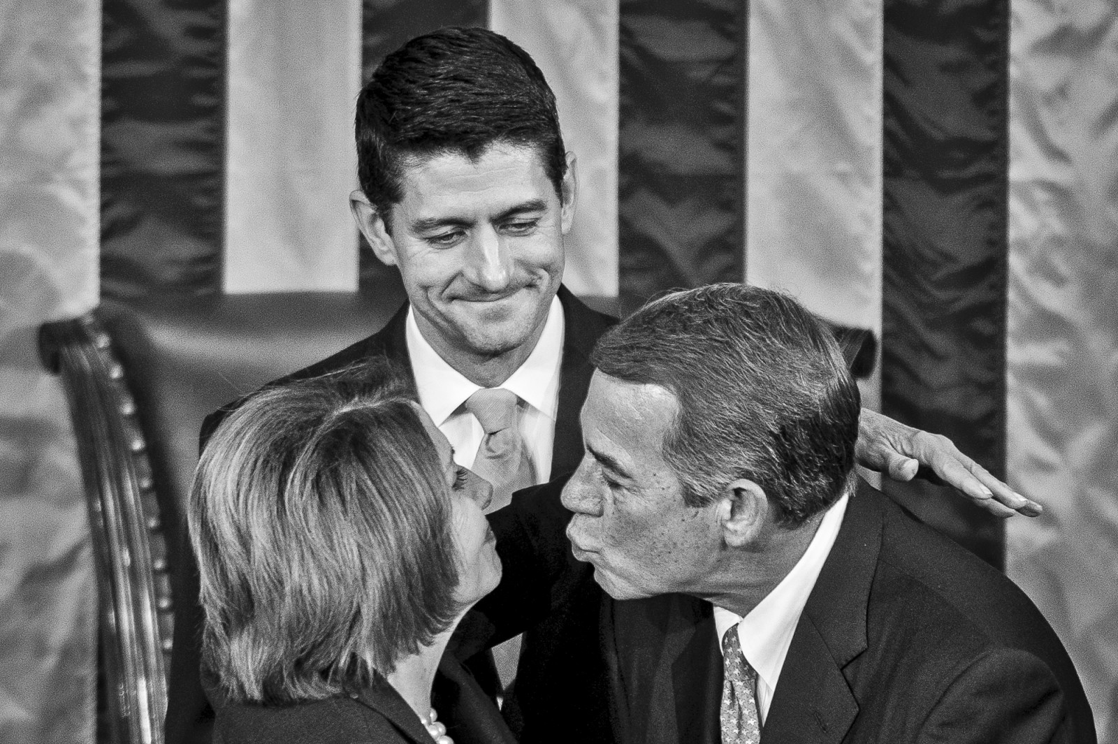 Speaker elect Paul Ryan (R-WI) looks on as Speaker John Boehner (R-OH) leans in to kiss Democratic Minority Leader Nancy Pelosi as he leaves the chair for the final time on October 29, 2015 in Washington, D.C. Earlier the outgoing Speaker, Rep. John Boehner (R-OH), gave his farewell address to Congress. He is retiring on October 30, 2015. Photo by Pete Marovich/UPI
